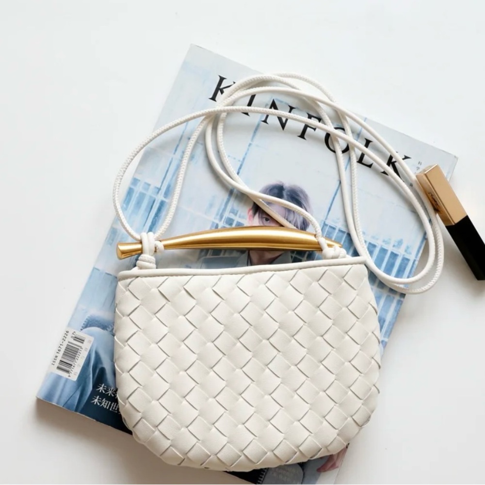 2 leather bags with sardine shaped metal handle. Colors black and white.